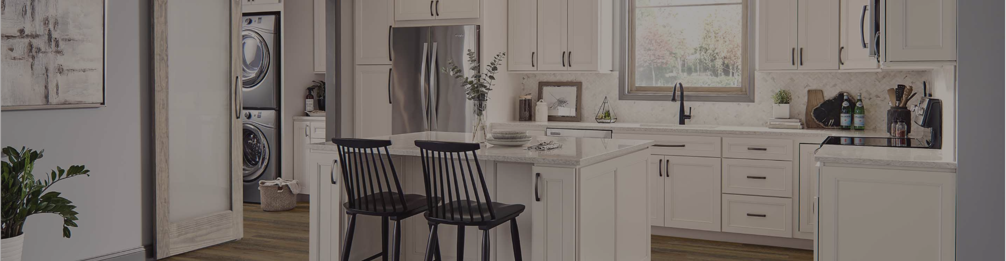 White cabinetry in a kitchen with dark wood floors
