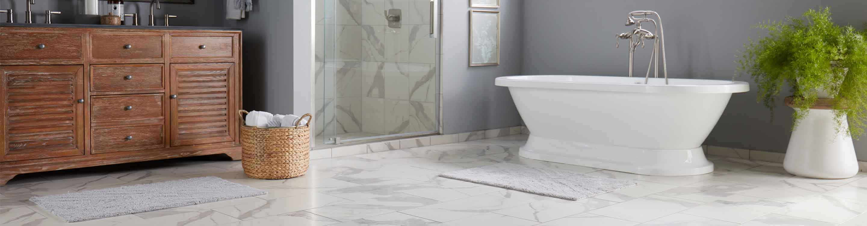 Bathroom with white tub, tile flooring, and backsplash in shower