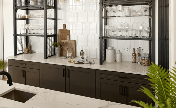 Marble countertop with dark cabinets, glassware, and bar tools in a modern setup.
